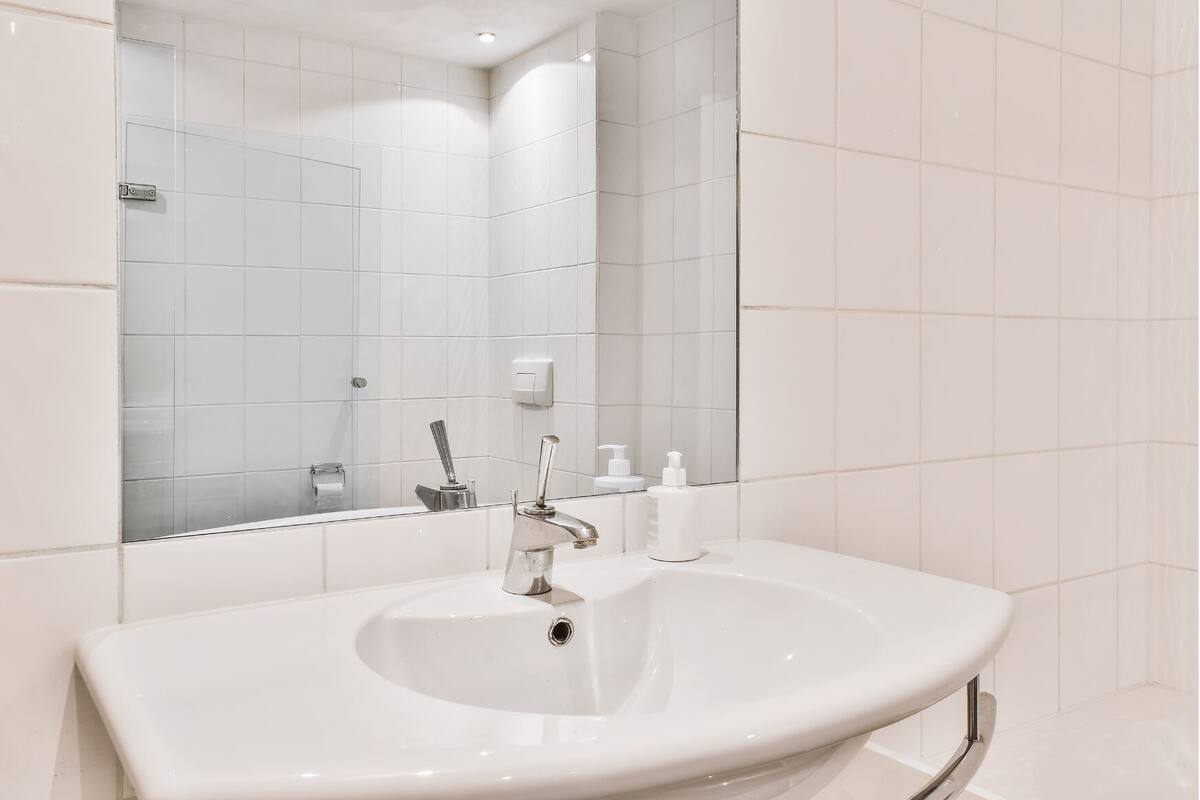 economy room ac with free airport drop | bathroom | shower, rainfall showerhead, free toiletries, bathrobes