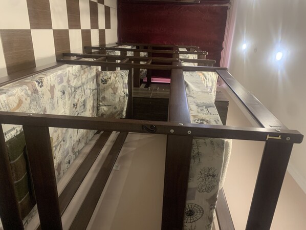 A bed with a metal frame and patterned bedding.
