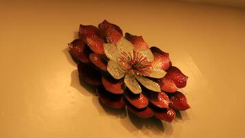 A decorative arrangement of red and white flowers on a wall.