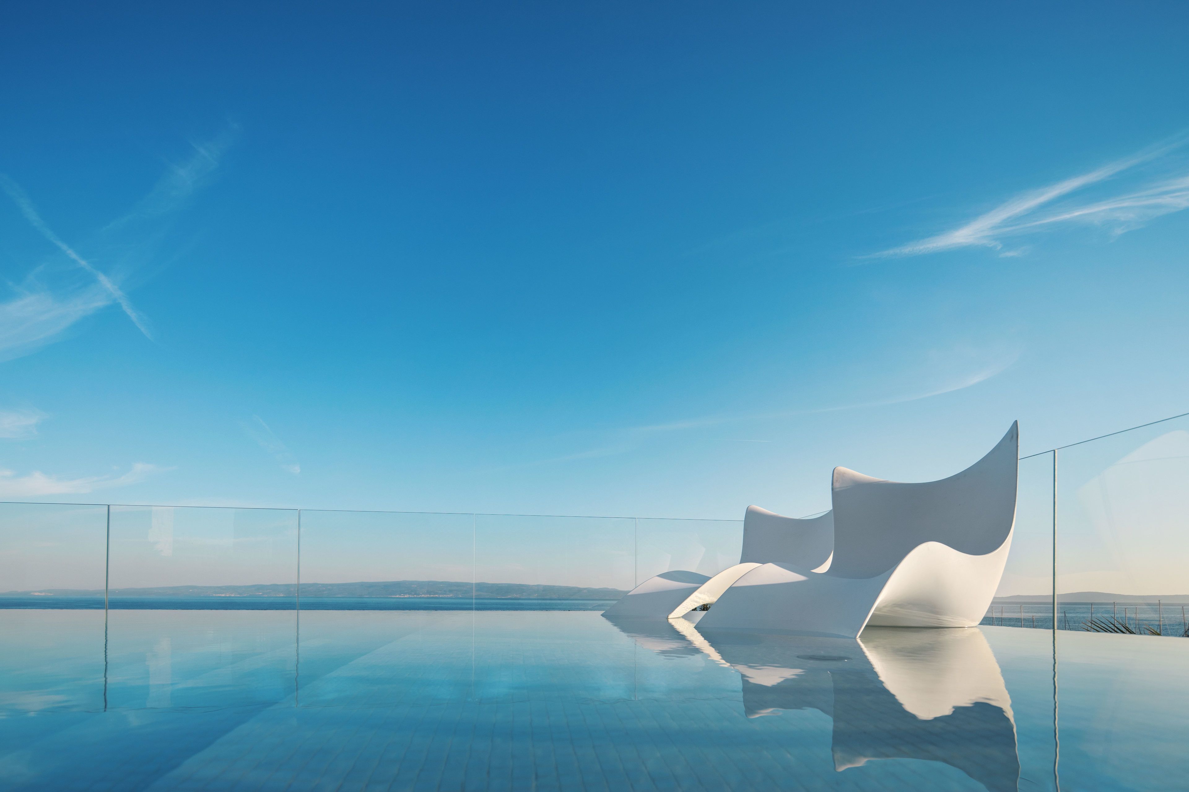 A modern infinity pool with a clear view of the horizon.