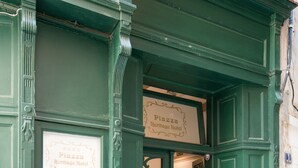 A green-painted building with a sign for 'Piazza Heritage Hotel' and 'Kitchen5 Food & Wine'. - Central Square Heritage Hotel (Split)