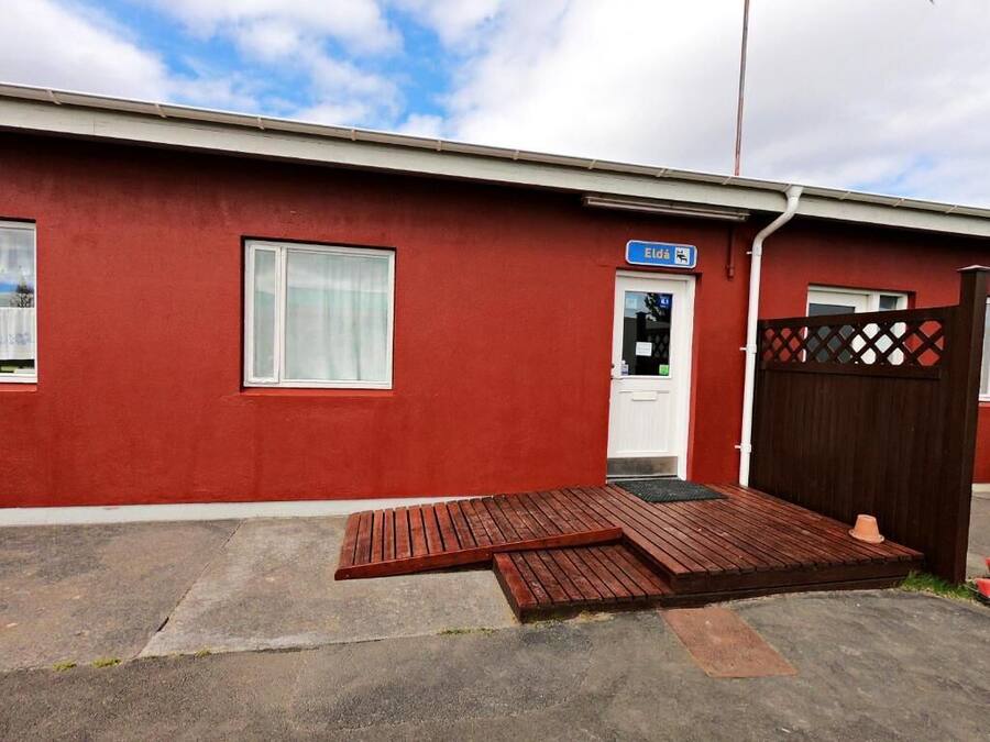 A red building with a white door and a blue sign reading "Eldad."