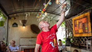 A man in a red shirt lifting a glass. - La Tour du Terroir (Rivesaltes)