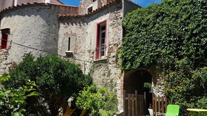 A stone building with a swimming pool, surrounded by greenery and outdoor furniture. - La Tour du Terroir (Rivesaltes)