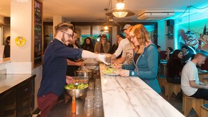 A group of people serving themselves food at a buffet in a restaurant. - Yeah Barcelona Hostel (Barcelona)