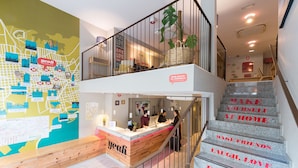 A reception desk with a map and a sign that reads "Only guests no outsiders." - Yeah Barcelona Hostel (Barcelona)
