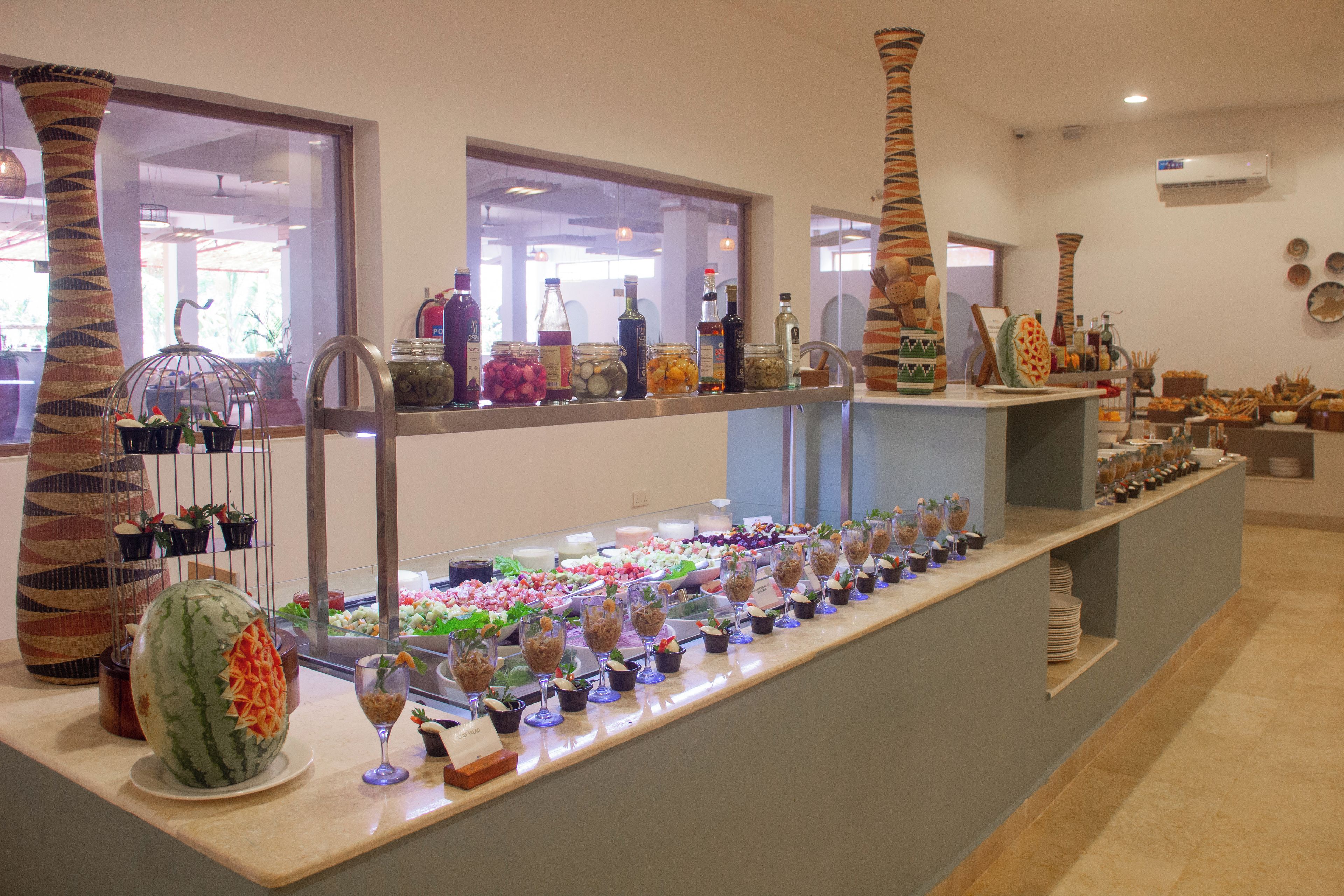 A buffet area with a variety of food items and beverages.