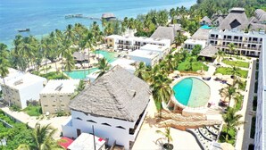 A resort with multiple buildings, a large swimming pool, and a view of the ocean. - Zanzibar Bay Resort (Marumbi)