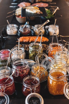 A buffet with various food items and condiments.
