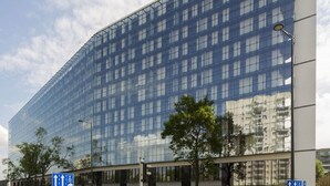 A modern glass building with a grid of windows and a flat facade. - Vola Residence (Warsaw)