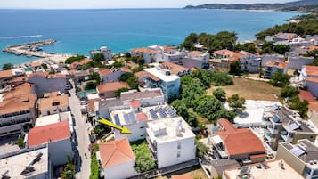 Stunning coastal views surround this Mediterranean-style residential area, with a pier extending into the clear blue sea.