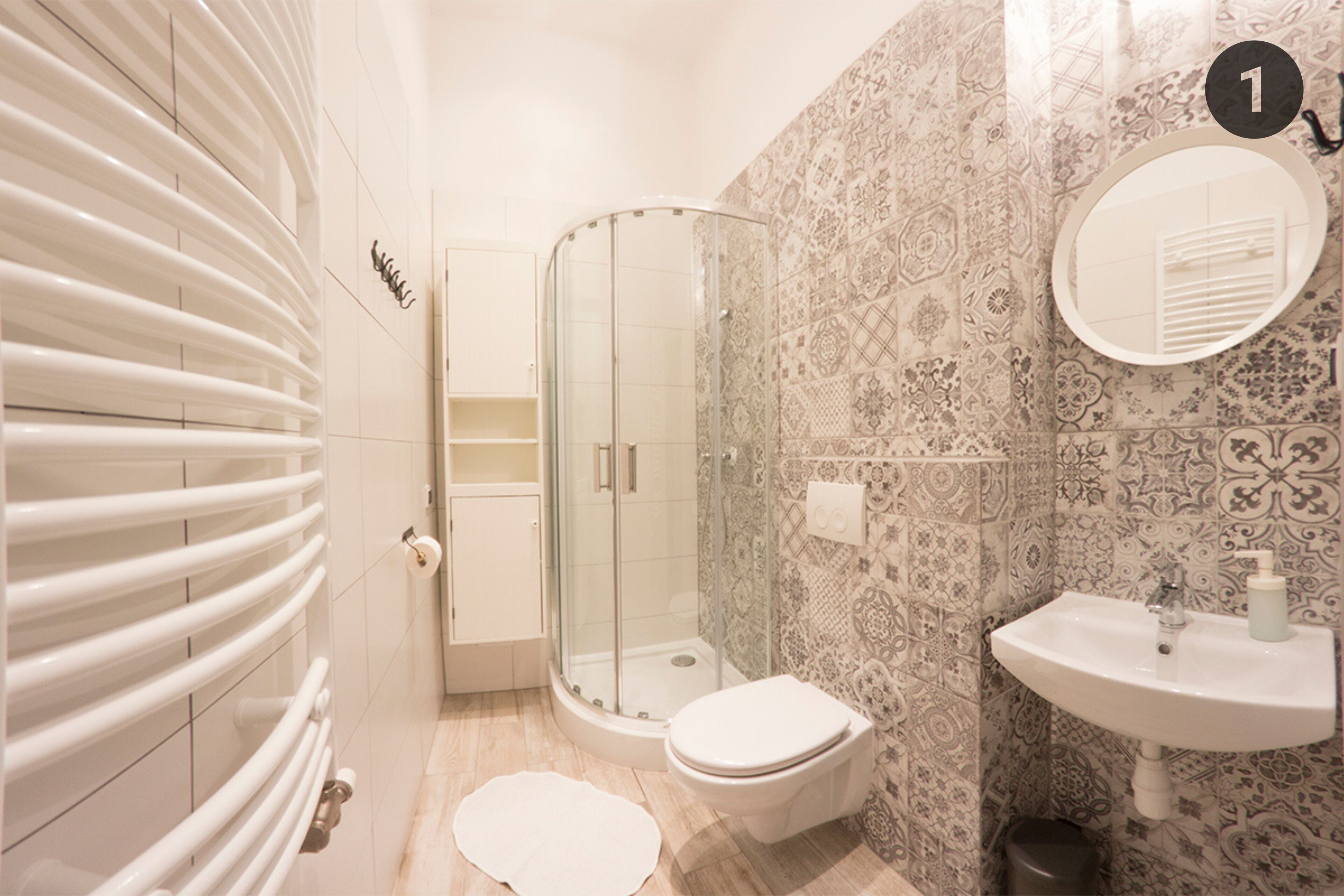 A bathroom with a shower, toilet, and sink.