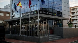 Ein modernes Gebäude mit dem Schild "Bea Beach Hostel" an der Fassade.