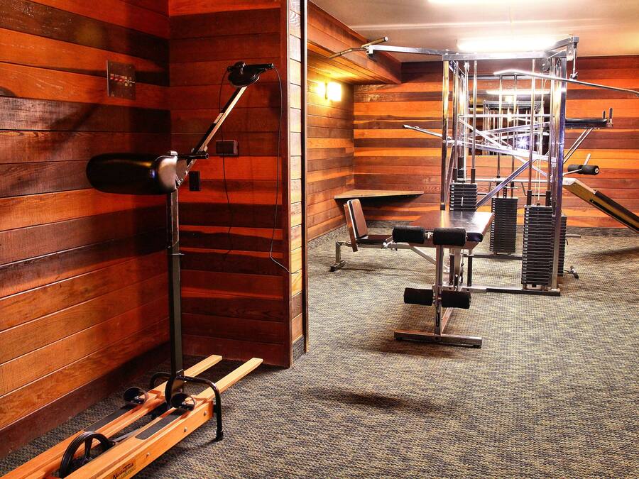 Un gimnasio con paredes de madera y diversos equipos de ejercicio.