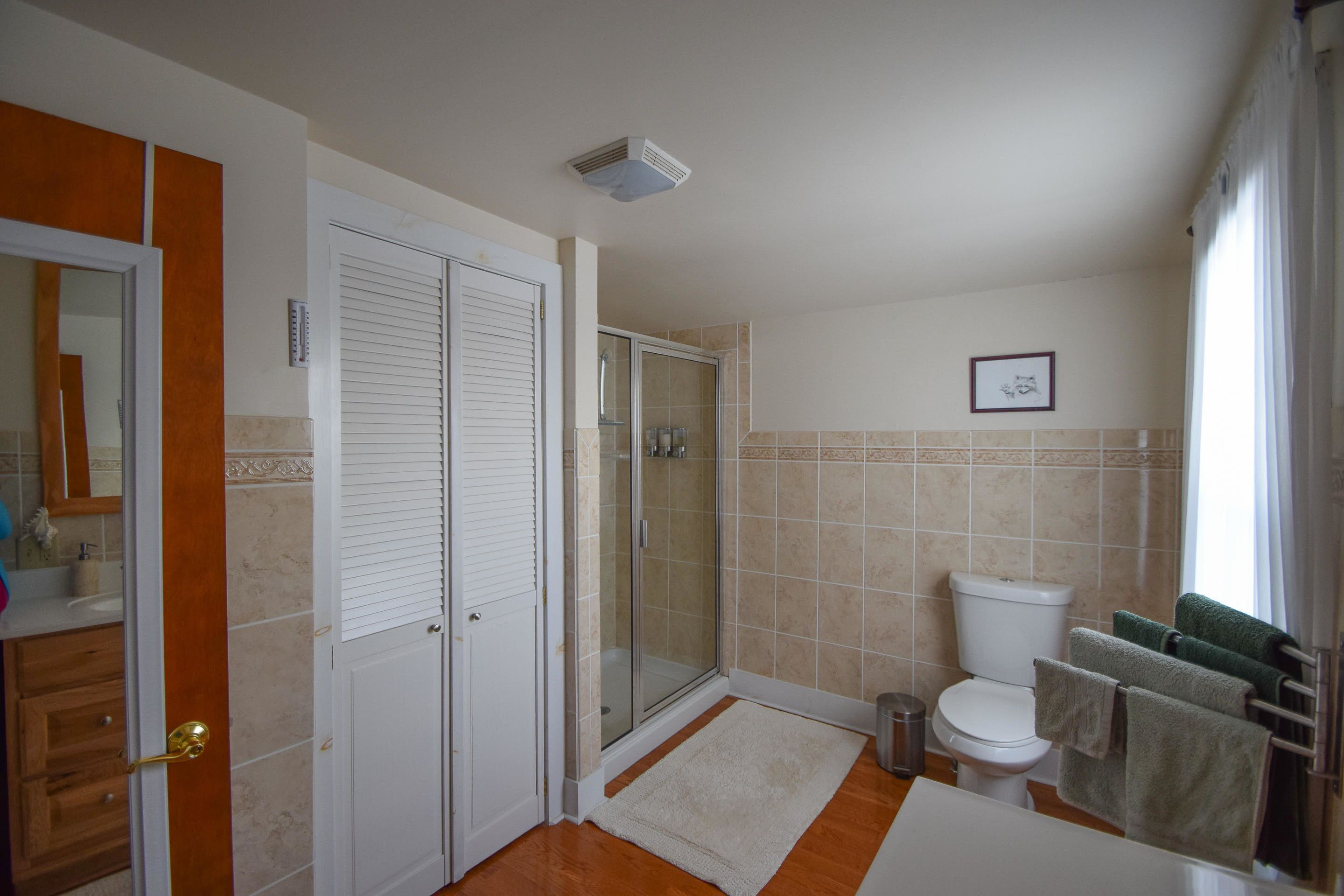 A bathroom with a shower, toilet, and sink.