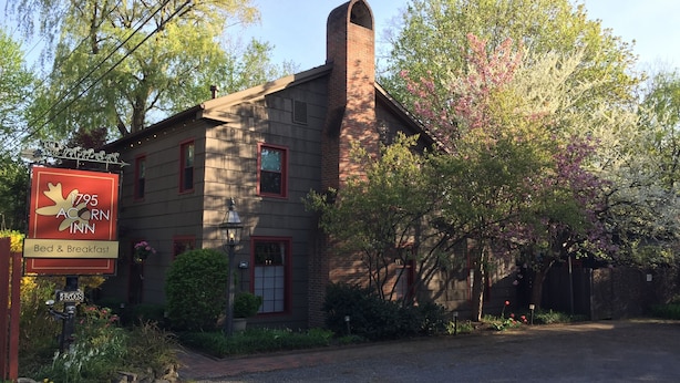 A rustic building with a sign for '1795 Acorn Inn' offering bed and breakfast. - 1795 Acorn Inn B&B (Canandaigua)