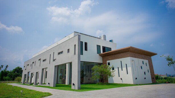 A modern building with a flat roof, large windows, and a flat facade. - Here is BNB (Zhongpu)