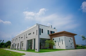 A modern building with a flat roof, large windows, and a flat facade. - Here is BNB (Zhongpu)