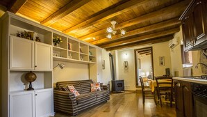 A cozy living room with a sofa, wooden cabinets, and a fireplace. - LE ROCCHE - Under the Castle, SMERALDO Apartment with SPA and Black River View (Ferentillo)