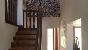 A staircase leading to a room with a wall covered in photos. - House with garden and pool near CAP D'AGDE (Agde)