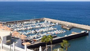 A marina with numerous boats docked, a pier, and a view of the sea. - Romantic Retreat In Prime Position With Stunning Views (Santiago del Teide)
