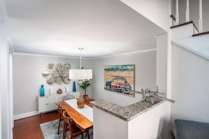Enjoy meals for two at the dining table in this well-organized kitchen with a small island and ample storage.