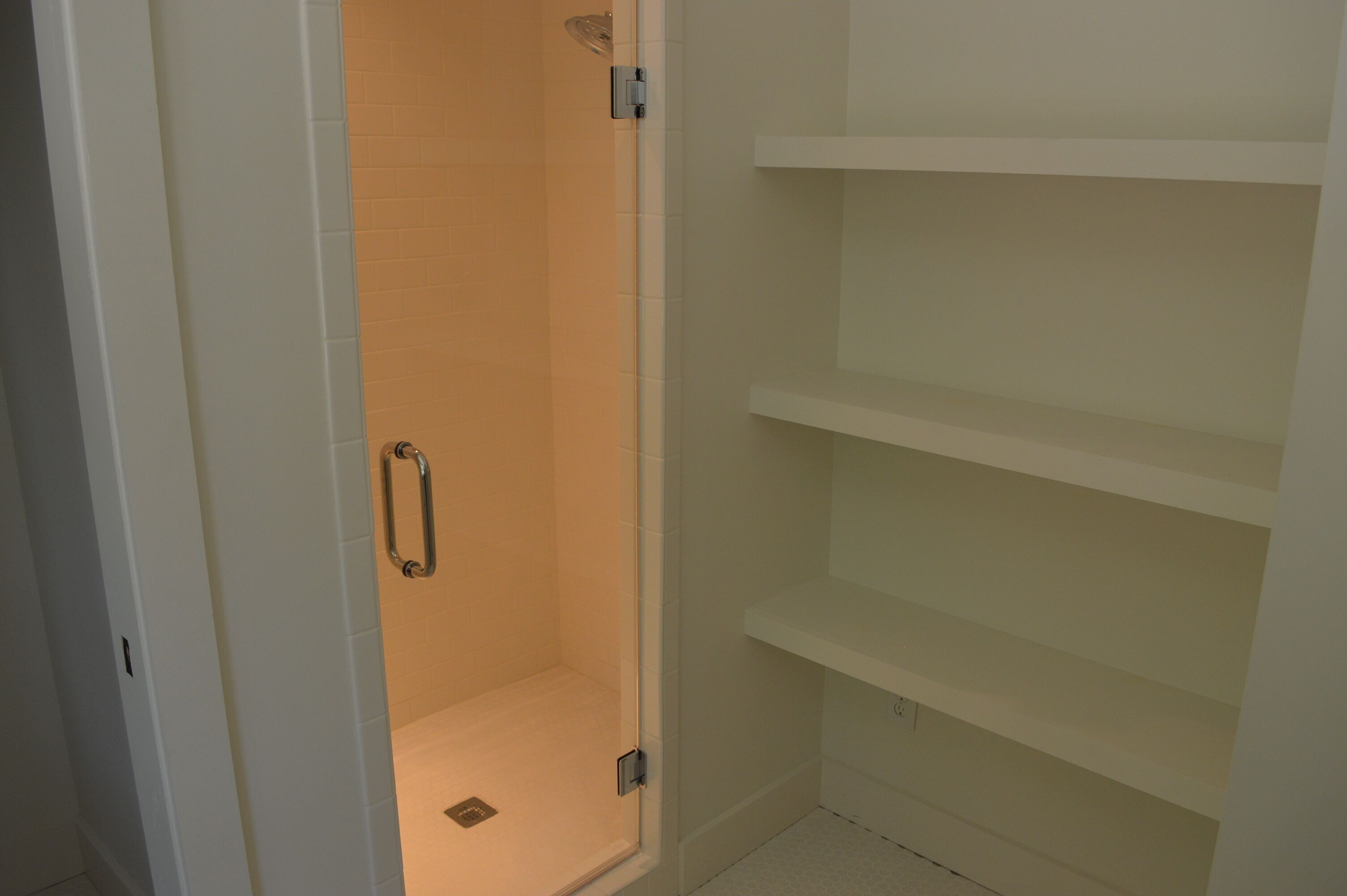 A bathroom with a shower, a toilet, and a sink.