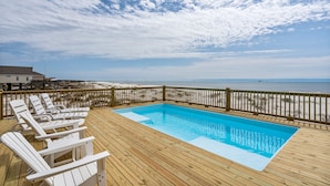 A wooden deck with a pool and beach view. - Gulf Front Home with 3 Master Bedrooms (Dauphin Island)