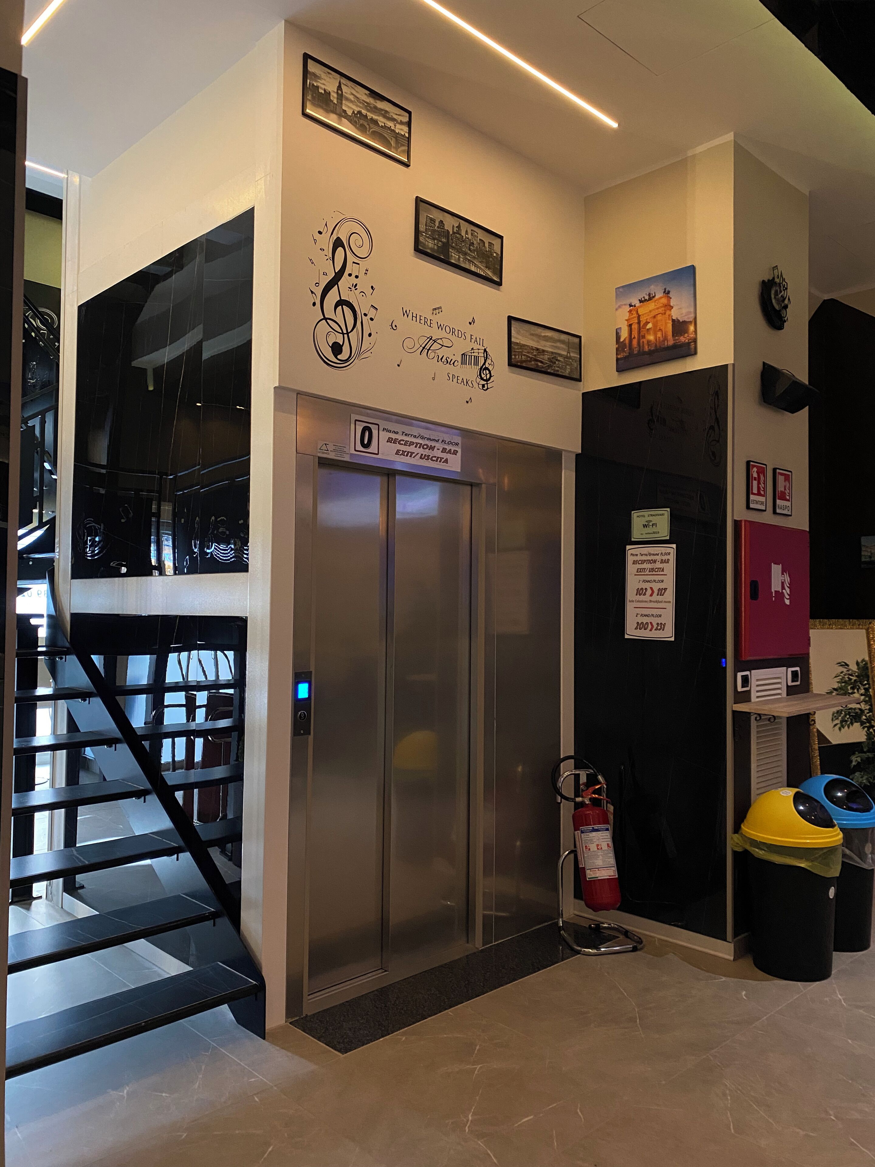 An elevator with a sign indicating it is the reception floor and an exit.