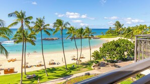 A beach view with palm trees, a sandy shore, and a clear blue sky. - The Beach Villas at Ko Olina by Real Select Vacations (Kapolei)