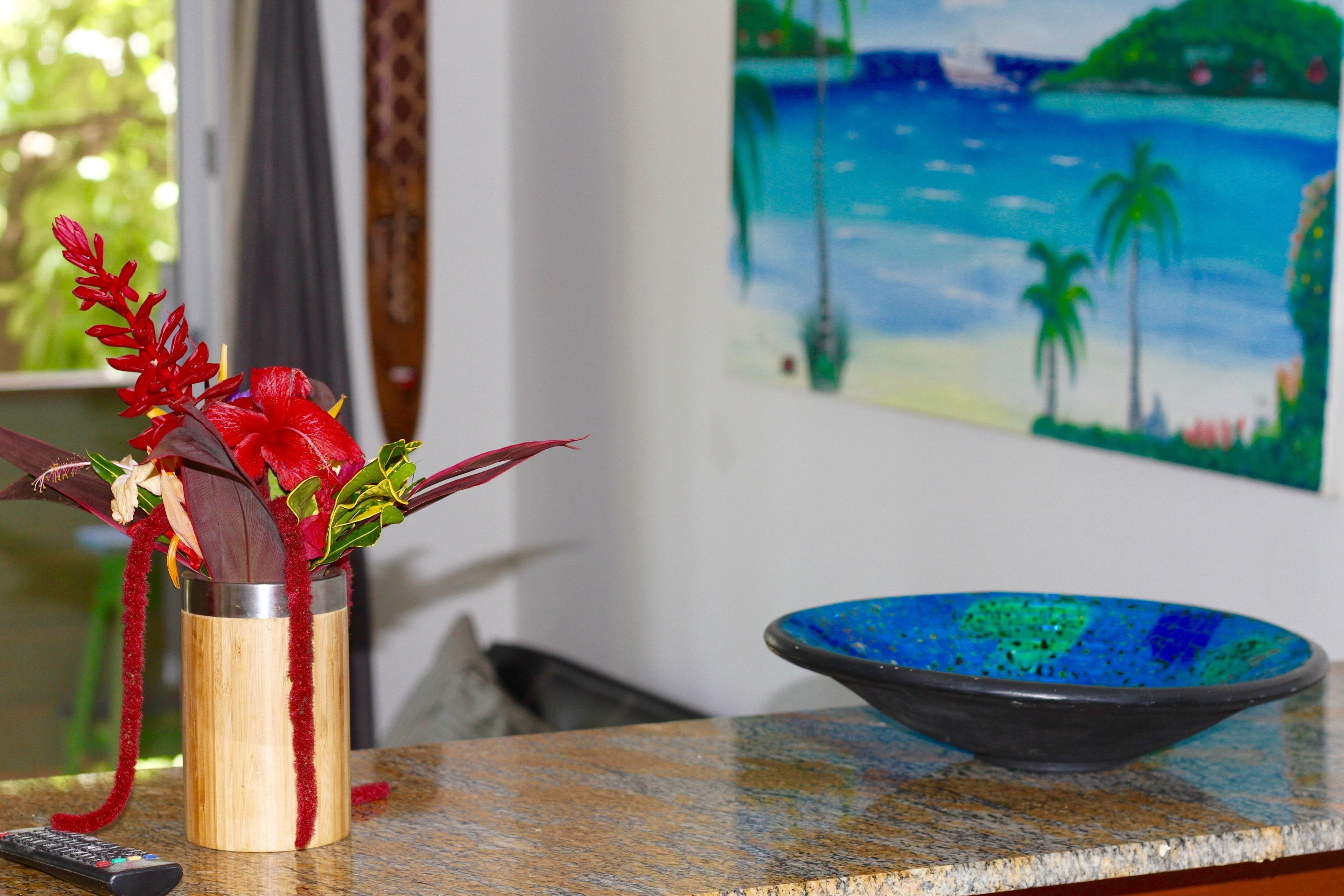 A kitchen counter with a decorative vase and a bowl.