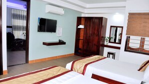A hotel room with two beds, a TV, a wardrobe, and a desk. - Khach San Yen Phu (Tuy Hoa)
