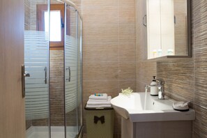 Shower, hair dryer, towels, toilet paper