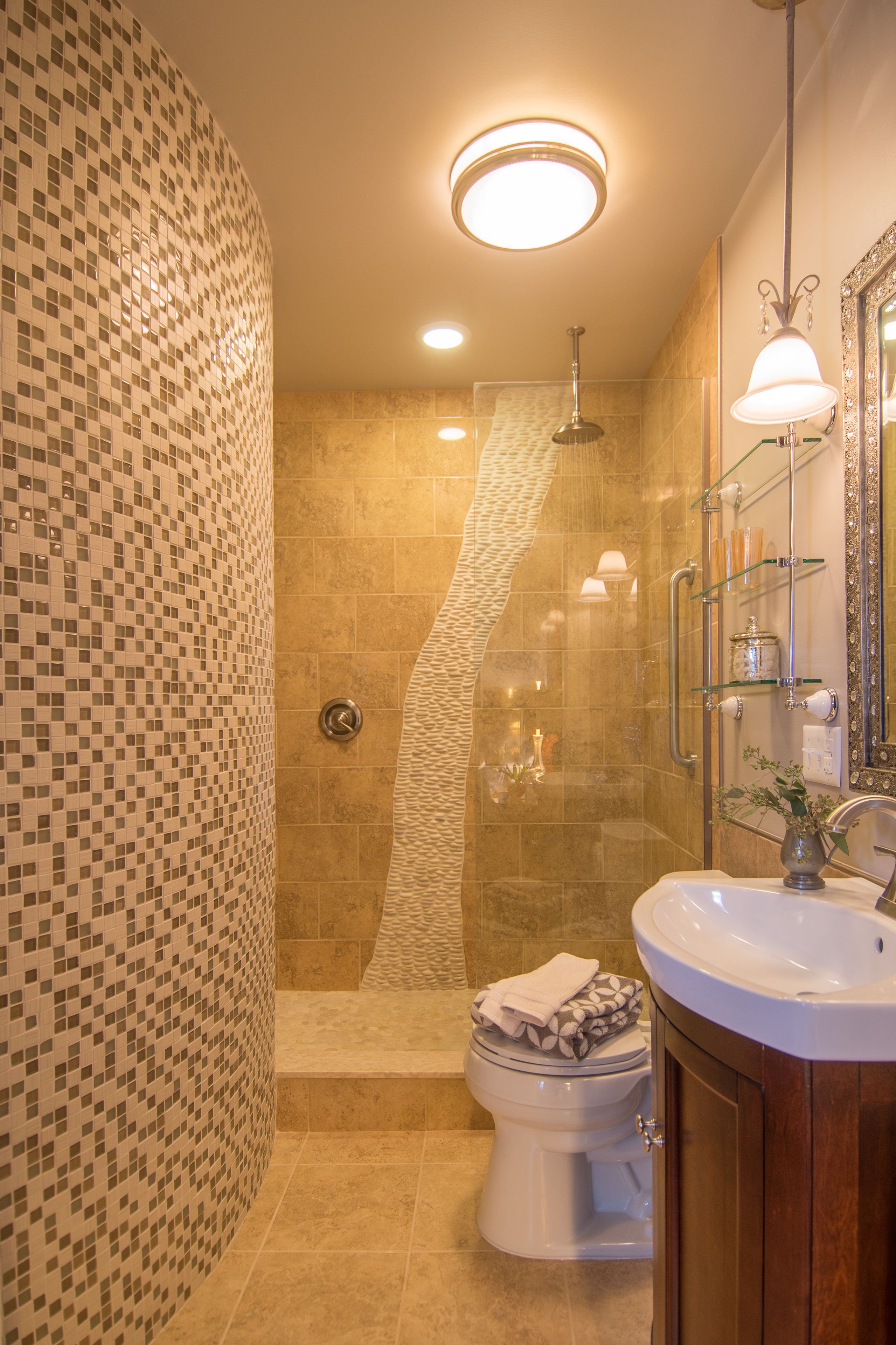 A bathroom with a shower, toilet, and sink.
