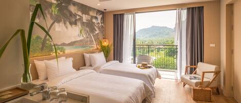 A hotel room with two beds, a balcony with a view, a chair, and a desk with a sink.