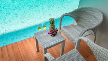 Relax by the pool with a refreshing drink in hand, surrounded by comfortable lounge chairs and a serene atmosphere.