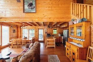 A cabin interior with a dining area, kitchen, and a wooden ceiling. - A+ Views & Location! > Parkway, Dollywood. Theater, Hot Tub, Games, Pet Friendly (Pigeon Forge)