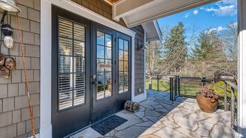 Enter a serene space with a welcoming door, windows, and a cozy porch.