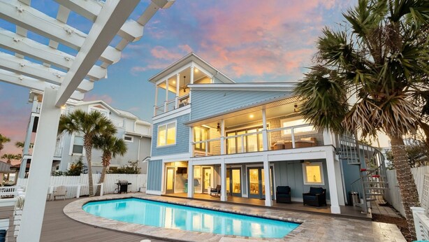 A two-story house with a pool, a covered deck, and a white fence. - Lake Front w/ Dock, Kayaks and Pool (Santa Rosa Beach)