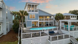 A two-story house with a pool, outdoor seating, and a covered patio area. - Lake Front w/ Dock, Kayaks and Pool (Santa Rosa Beach)