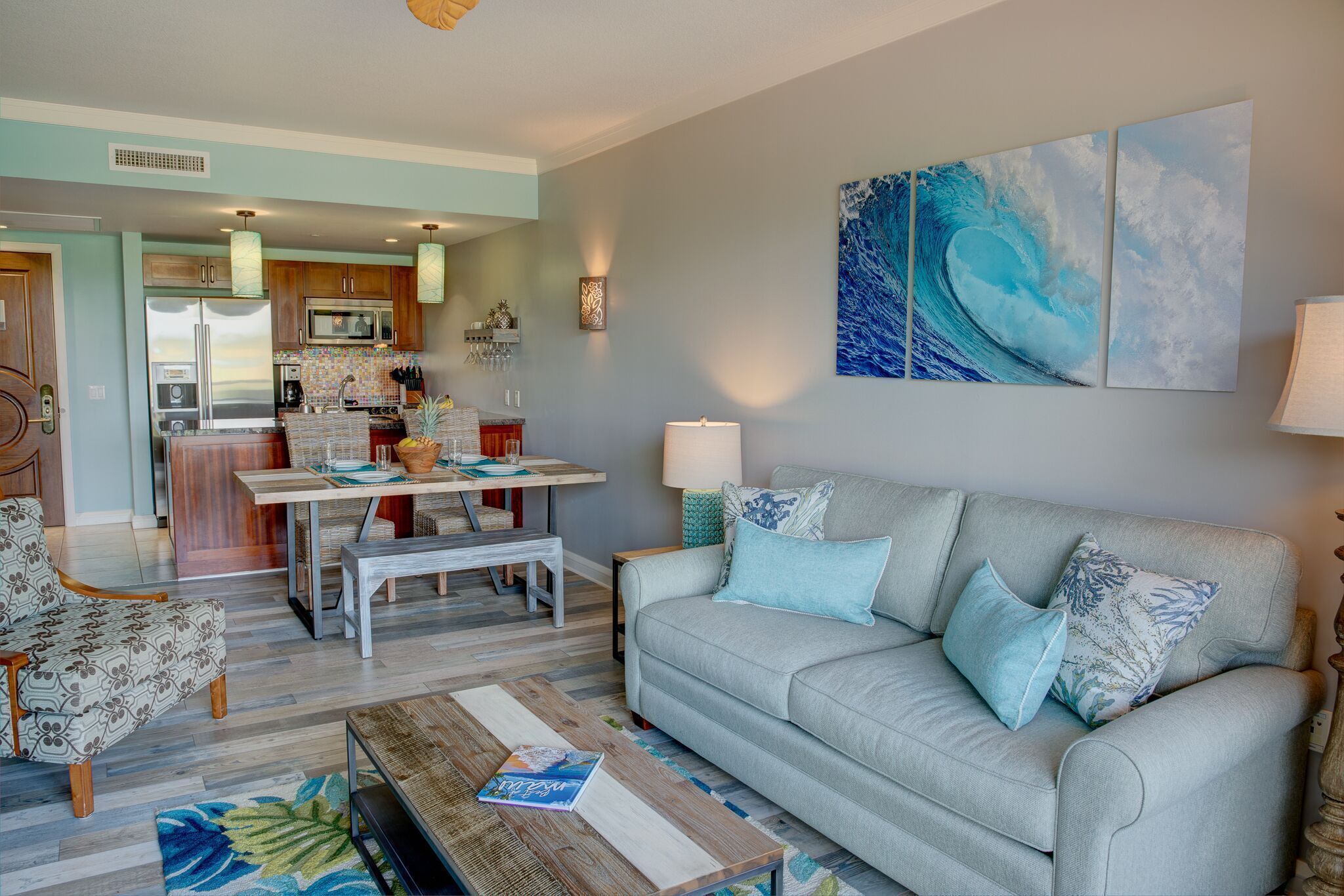 A living room with a sofa, coffee table, and a dining area with a table and chairs.