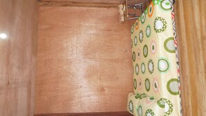 A wooden interior with a patterned curtain.