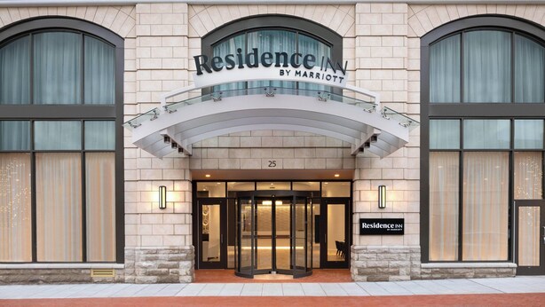 The entrance of a Marriott Residence Inn with a revolving door, large windows, and a stone facade. - Residence Inn Stamford Downtown (Stamford)