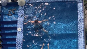 A rectangular swimming pool with a tiled edge and a clear blue interior. - Hoi An Sea Sunset Villa & Bar (Da Nang)