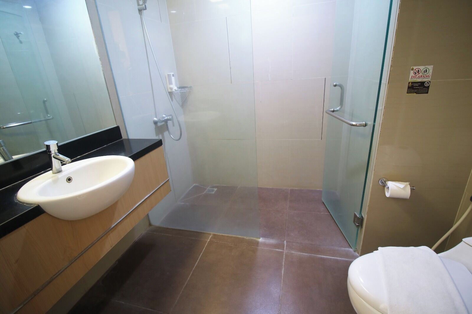 A bathroom with a sink, toilet, and shower.