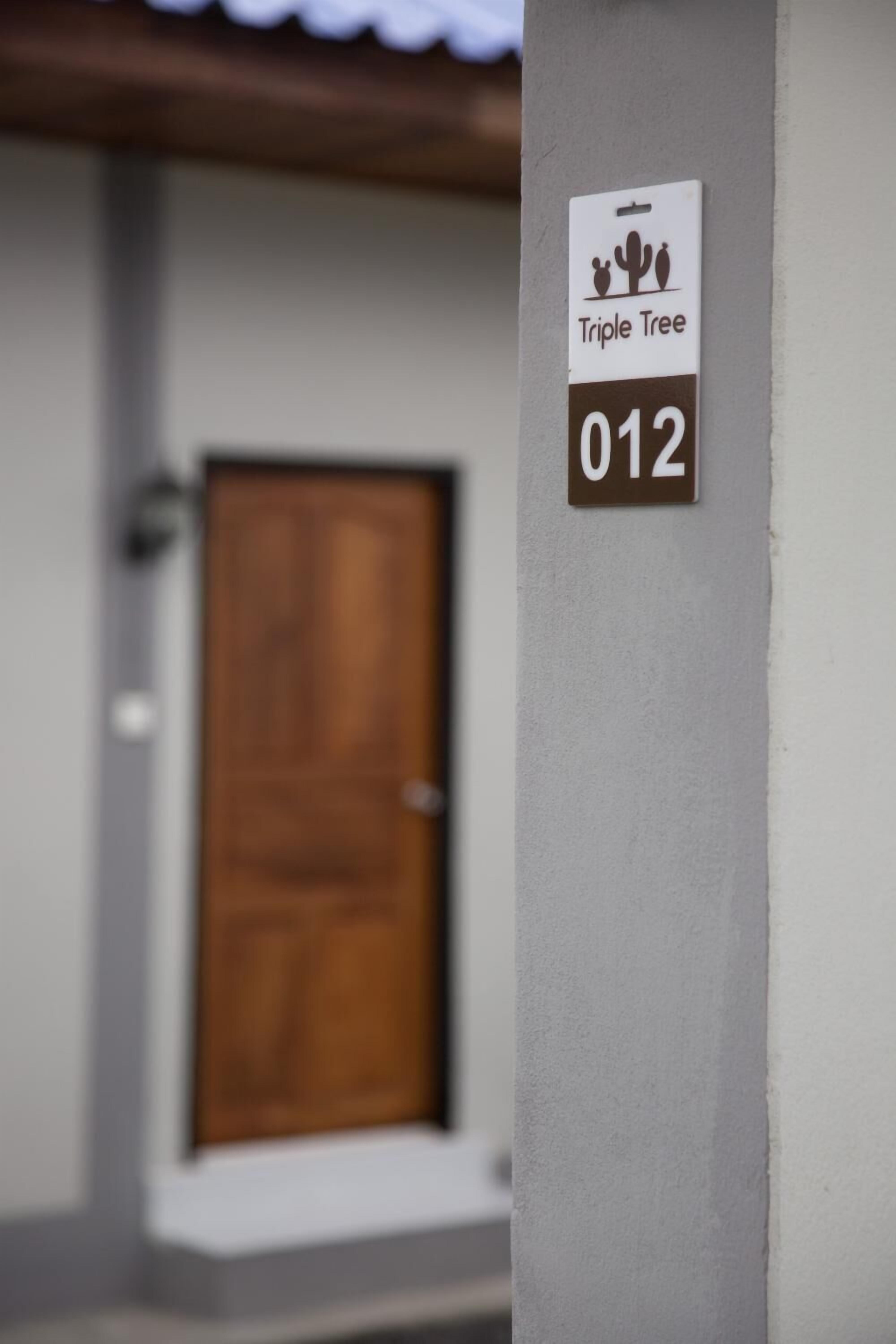 A wall-mounted sign with a cactus logo and the number 012.