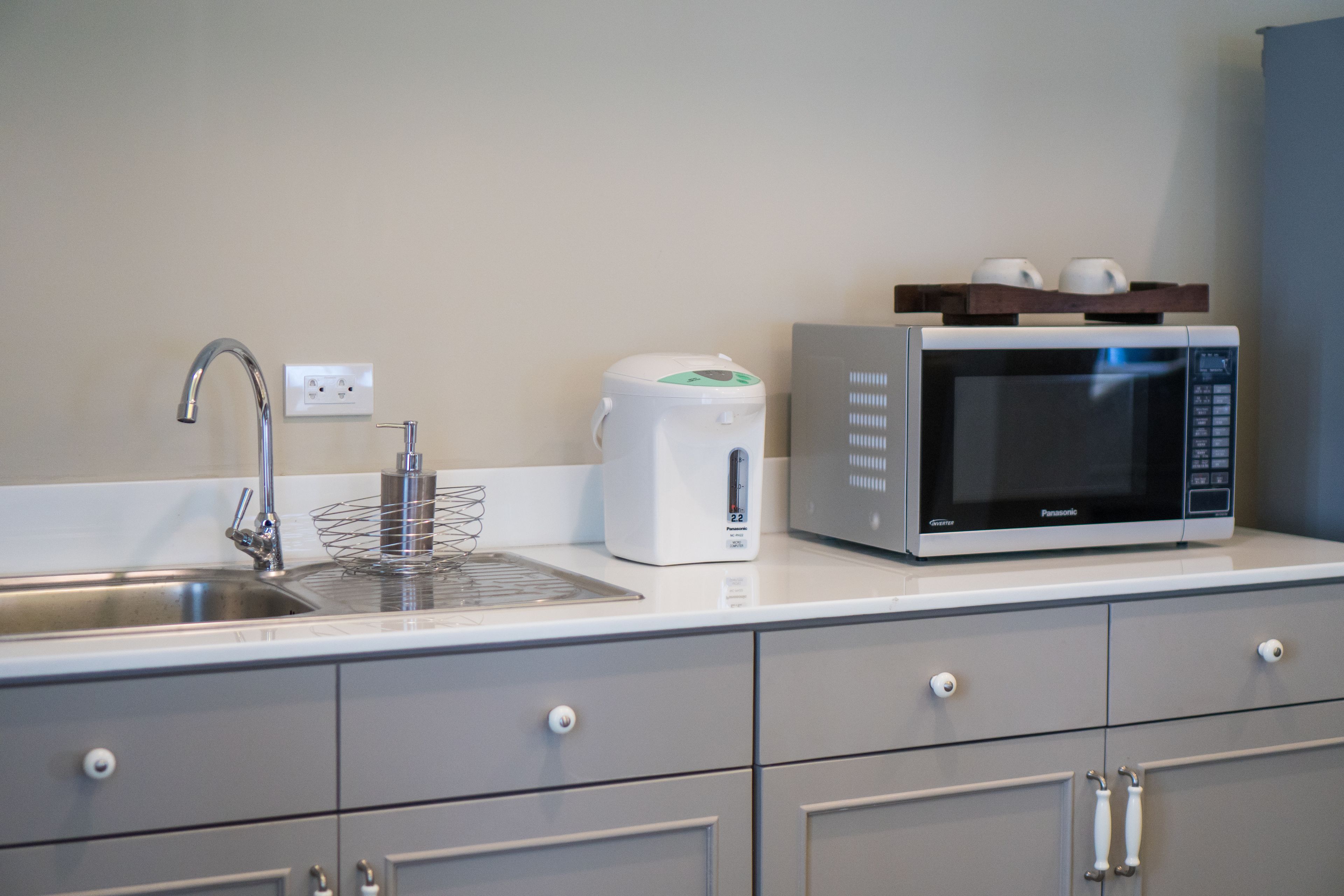 A kitchen with a sink, a microwave, and a coffee maker.