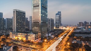 A high-rise building with a modern glass facade, surrounded by other skyscrapers in a cityscape. - The Langham, Hefei (Hefei)