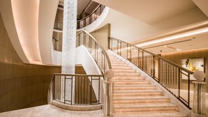 A grand, modern interior with a marble staircase, high ceilings, and a luxurious ambiance. - The Langham, Hefei (Hefei)