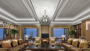 A spacious living room with a large central coffee table, comfortable seating, and a chandelier. - The Langham, Hefei (Hefei)